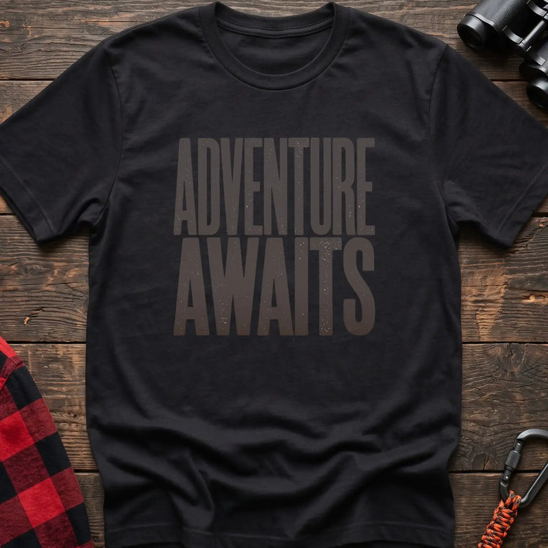 Black t-shirt with large distressed gray text reading Adventure Awaits
