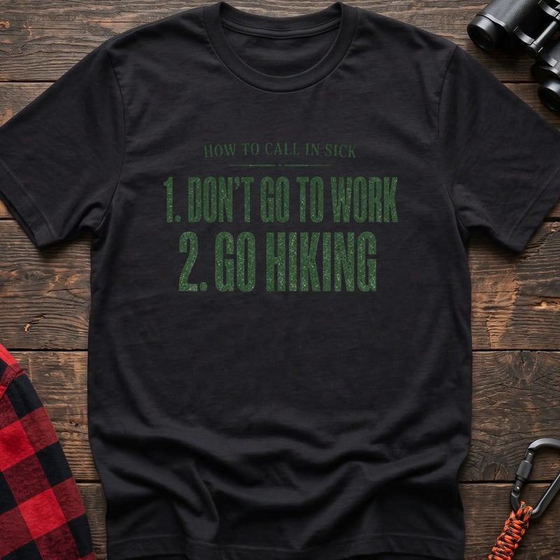 Black cotton t-shirt with How to Call in Sick Don’t Go to Work Go Hiking text on rustic wood