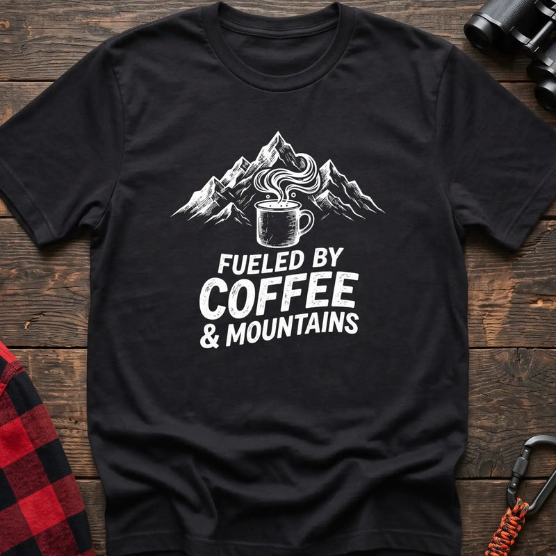 Black t-shirt with white graphic of a steaming coffee mug in front of mountains and the text Fueled by Coffee & Mountains