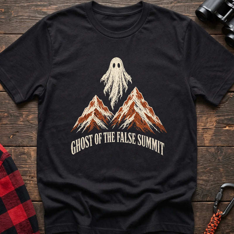 Black cotton t-shirt with a ghost over mountains graphic and Ghost of the False Summit text on rustic wood