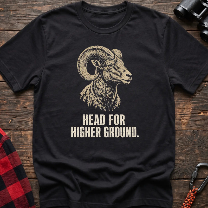 Black cotton t-shirt with a bighorn ram graphic and Head for Higher Ground text on rustic wood