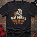Black cotton t-shirt with a Bigfoot graphic and Hide and Seek Champion October Division text on rustic wood