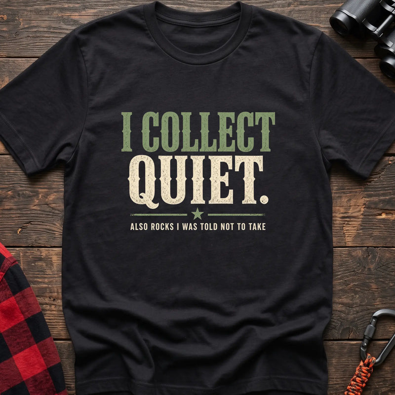 Black cotton t-shirt with I Collect Quiet Also Rocks I Was Told Not to Take text on rustic wood
