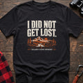 Black cotton t-shirt with a mountain jeep graphic and I Did Not Get Lost I Declared a Scenic Emergency text on rustic wood