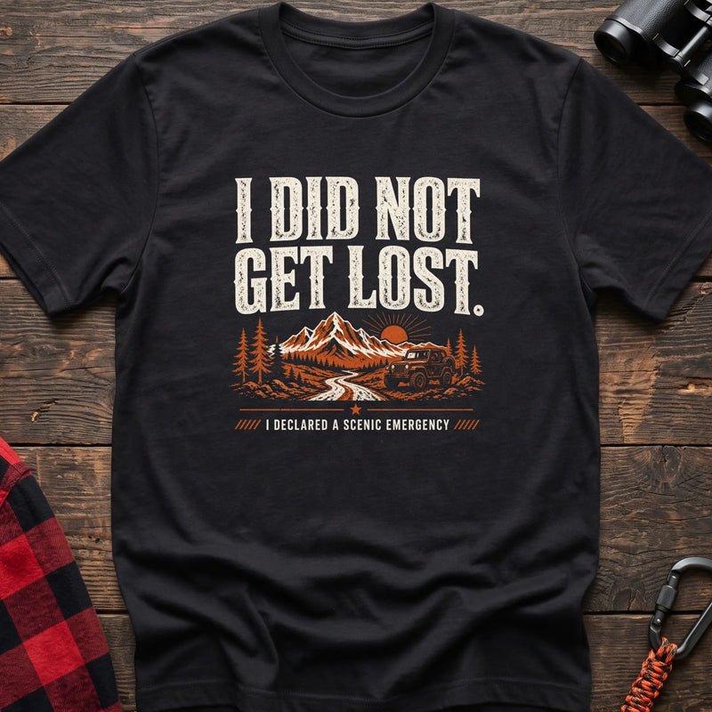 Black cotton t-shirt with a mountain jeep graphic and I Did Not Get Lost I Declared a Scenic Emergency text on rustic wood