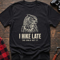 Black cotton t-shirt with an owl graphic and I Hike Late The Owls Get It text on rustic wood