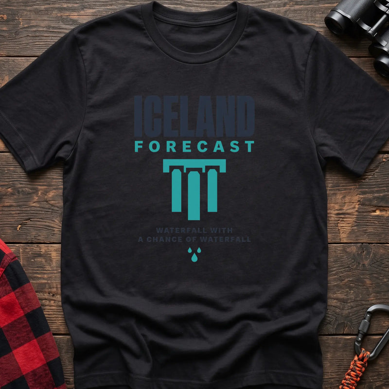 Black cotton t-shirt with an Iceland Forecast graphic and Waterfall with a Chance of Waterfall text on rustic wood