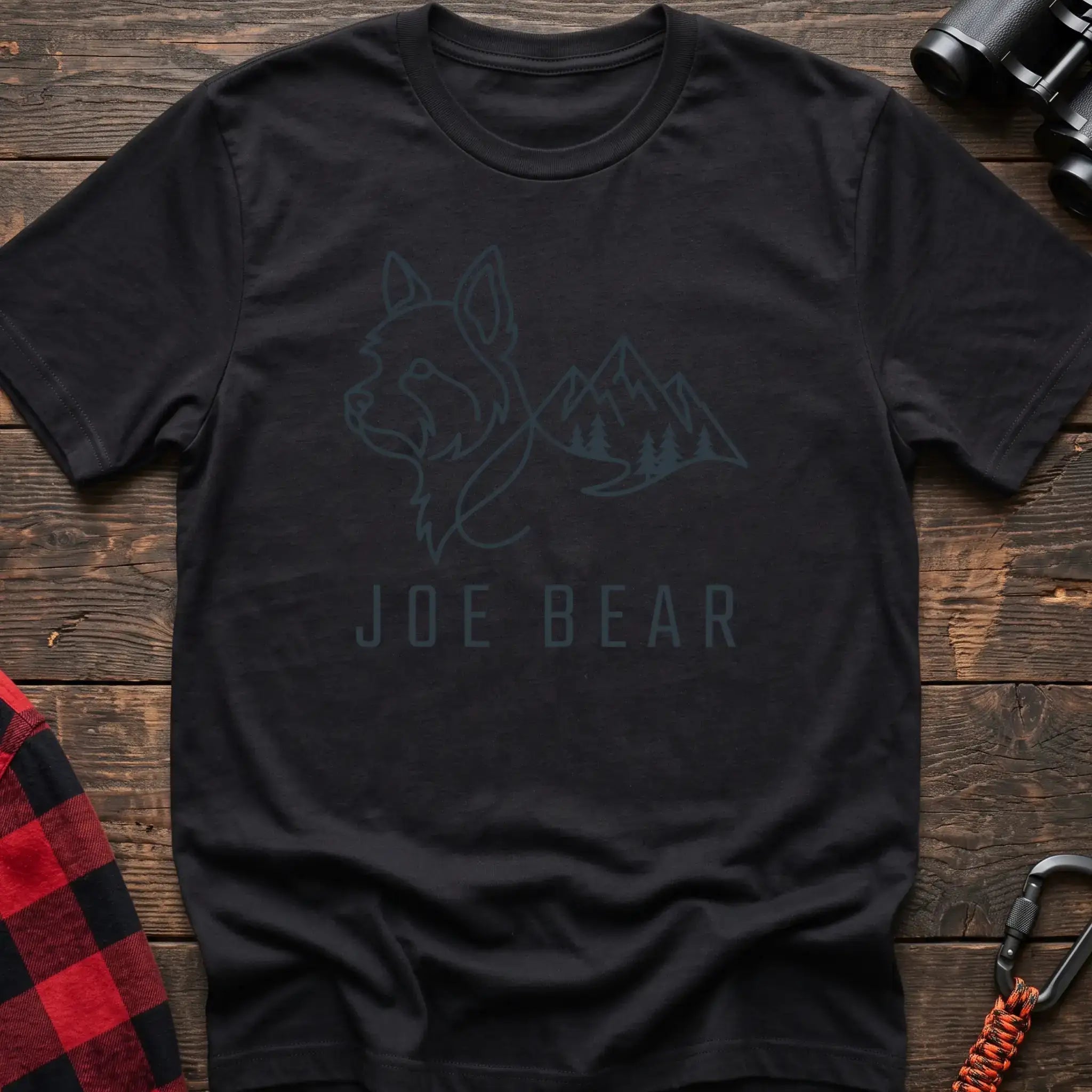Black t-shirt with dark line art of a yorkie dog head blending into mountains and pine trees, with the text Joe Bear