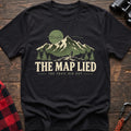 Black cotton t-shirt with a hiker and mountain graphic and The Map Lied The Trail Did Not text on rustic wood