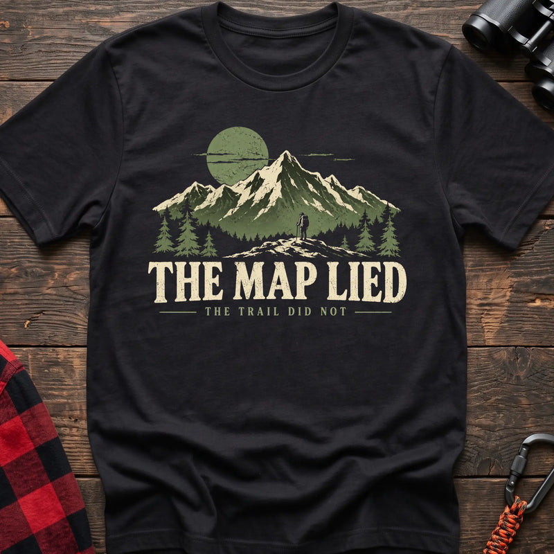 Black cotton t-shirt with a hiker and mountain graphic and The Map Lied The Trail Did Not text on rustic wood