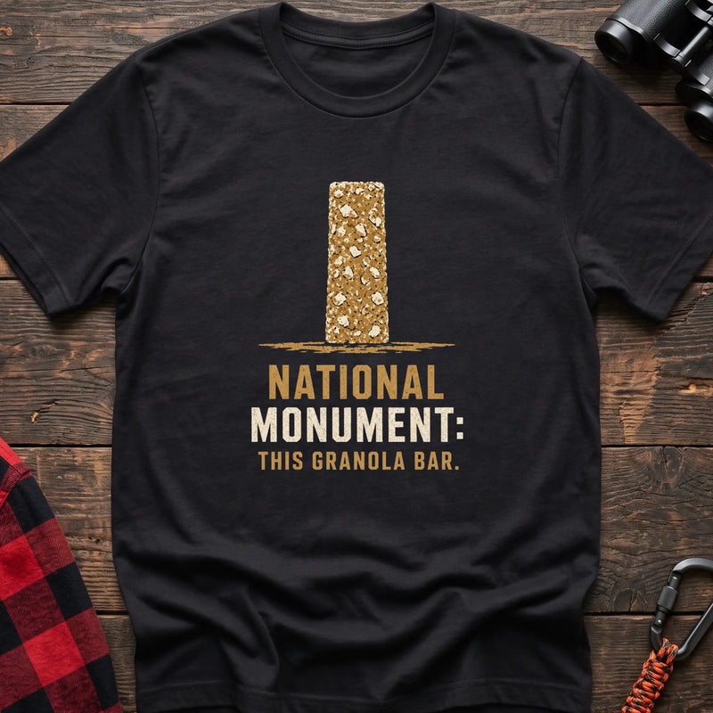 Black cotton t-shirt with a granola bar graphic and National Monument This Granola Bar text on rustic wood