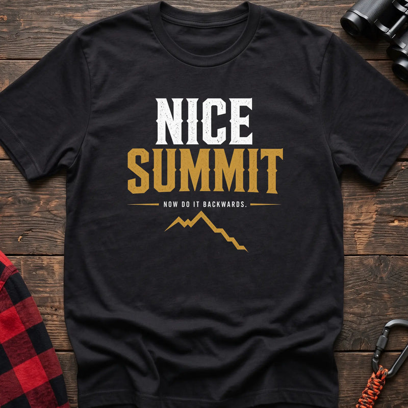 Black cotton t-shirt with a mountain graphic and Nice Summit Now Do It Backwards text on rustic wood