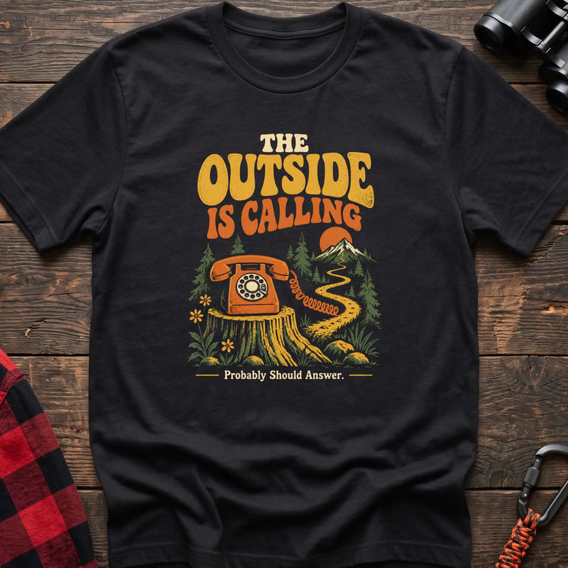 Black cotton t-shirt with a rotary phone on a stump graphic and The Outside Is Calling text on rustic wood