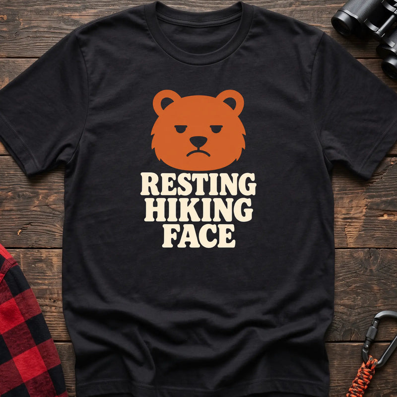 Black cotton t-shirt with a grumpy bear graphic and Resting Hiking Face text on rustic wood