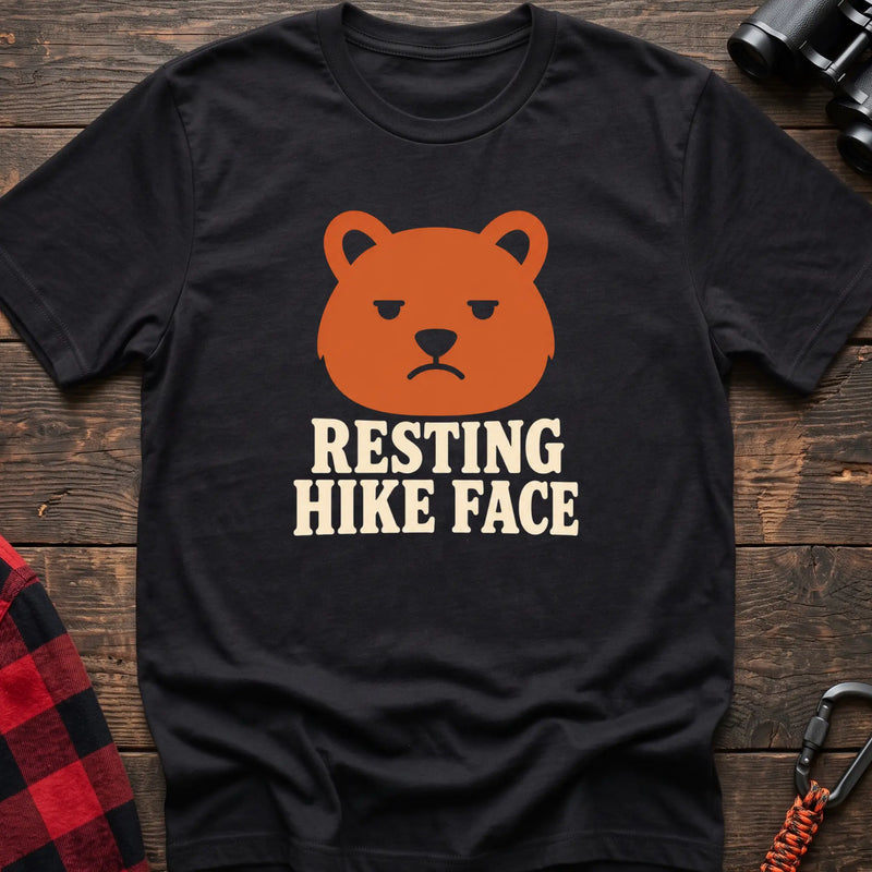 Black cotton t-shirt with a grumpy bear graphic and Resting Hike Face text on rustic wood
