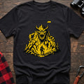 Black t-shirt with a pixel-art illustration of a hiker facing a large horned mountain monster with a health bar above it, laid flat on a wooden surface.