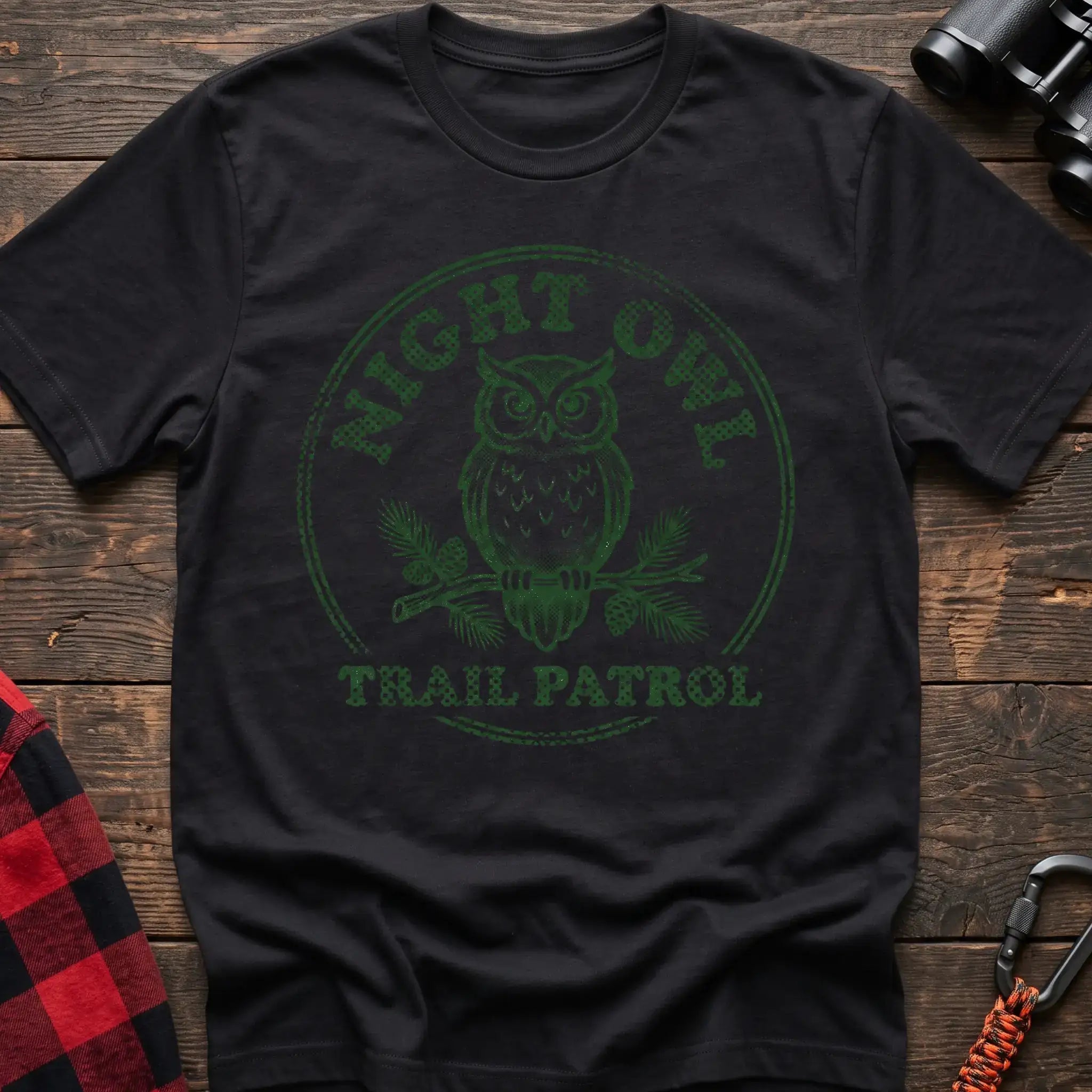 Black t-shirt with green owl on a pine branch graphic and the text Night Owl Trail Patrol