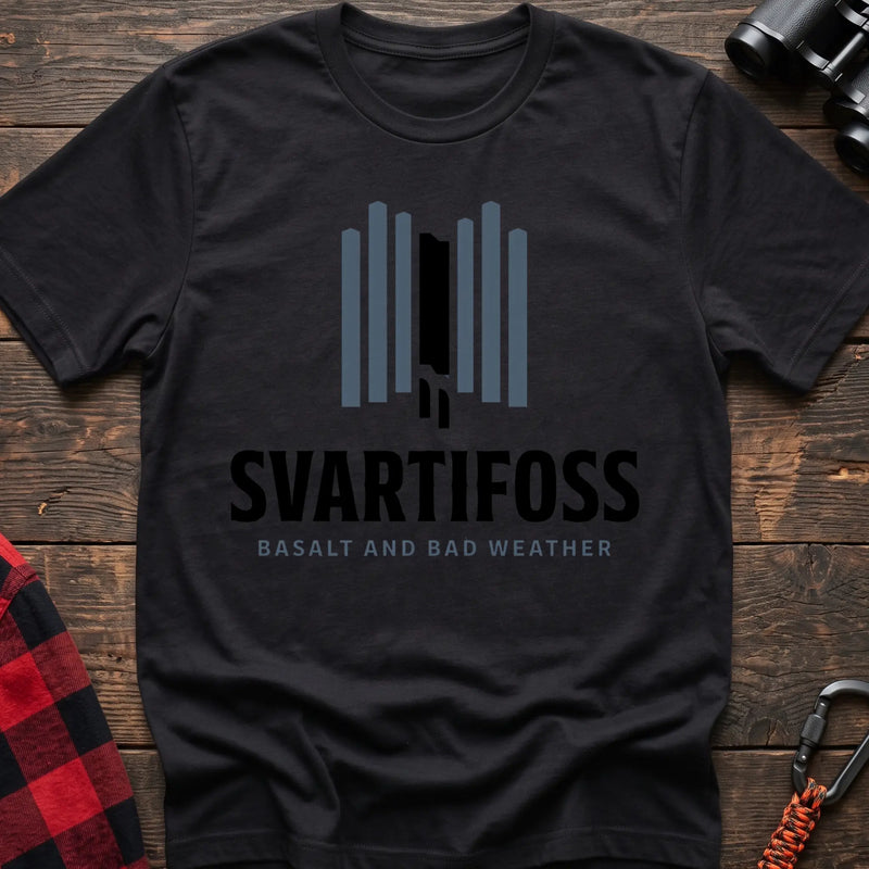 Black cotton t-shirt with a basalt column graphic and Svartifoss Basalt and Bad Weather text on rustic wood