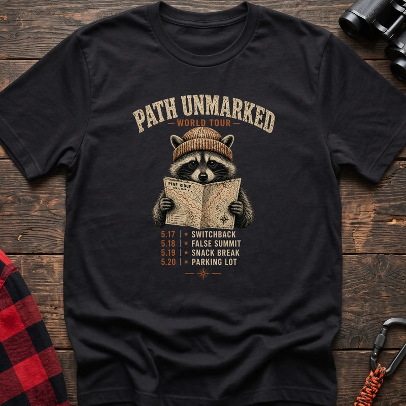 Black cotton t-shirt with a raccoon holding a trail map and Path Unmarked World Tour text on rustic wood