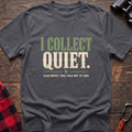 Charcoal cotton t-shirt with I Collect Quiet Also Rocks I Was Told Not to Take text on rustic wood