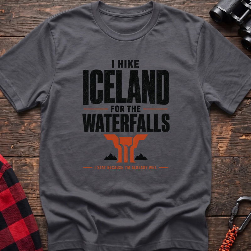 Charcoal cotton t-shirt with a waterfall graphic and I Hike Iceland for the Waterfalls text on rustic wood
