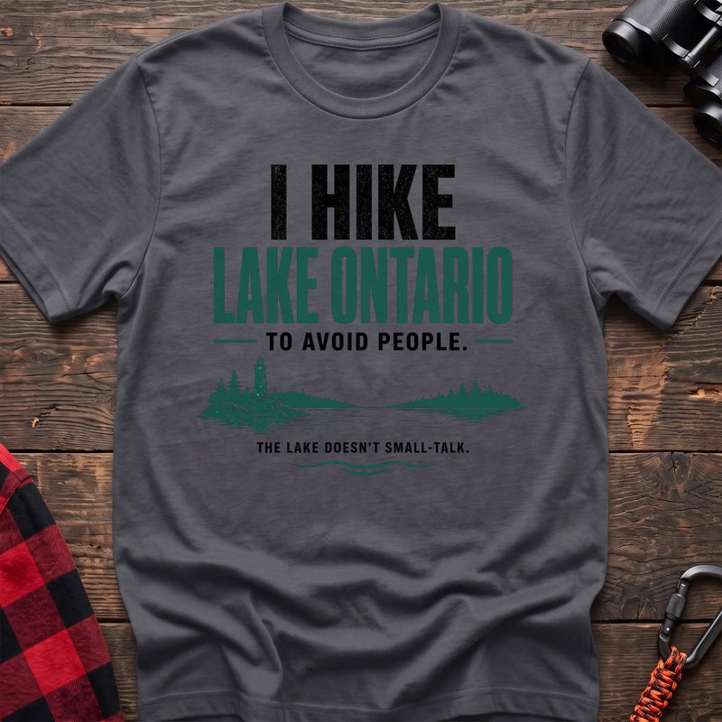 Charcoal cotton hiking t-shirt with lighthouse and lake graphic and "I hike Lake Ontario to avoid people – the lake doesn't small-talk" quote