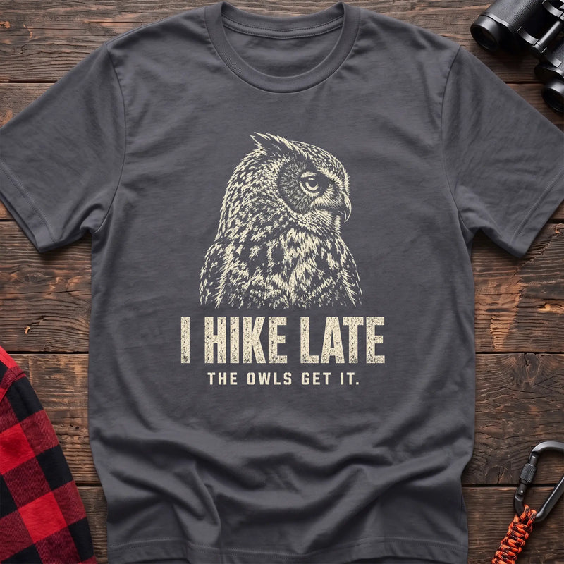 Charcoal cotton t-shirt with an owl graphic and I Hike Late The Owls Get It text on rustic wood