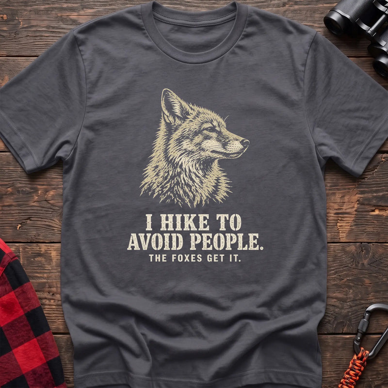 Charcoal cotton t-shirt with a fox graphic and I Hike to Avoid People The Foxes Get It text on rustic wood