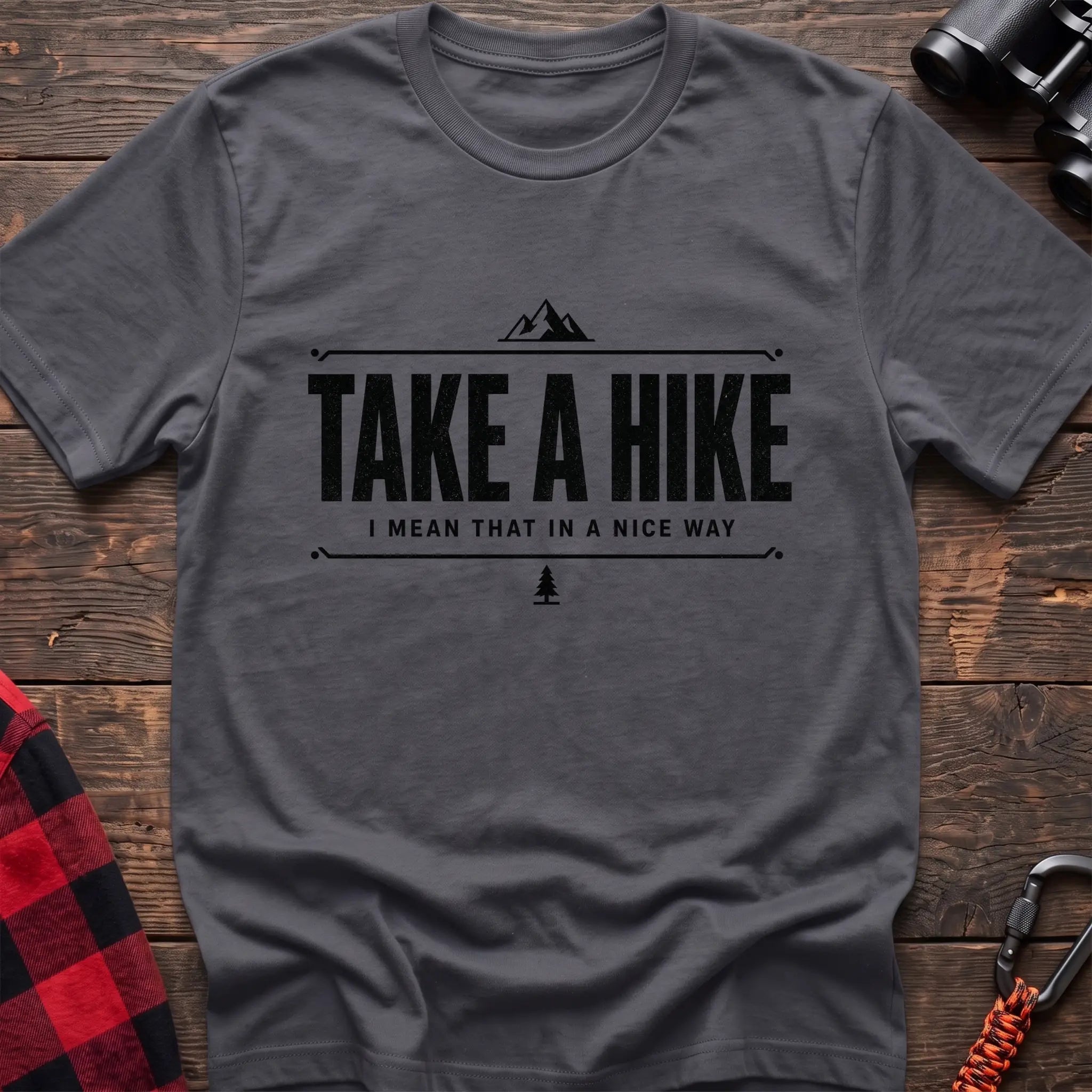 Charcoal cotton hiking t-shirt with "Take a Hike I Mean That in a Nice Way" quote, mountain icon, and pine tree graphic