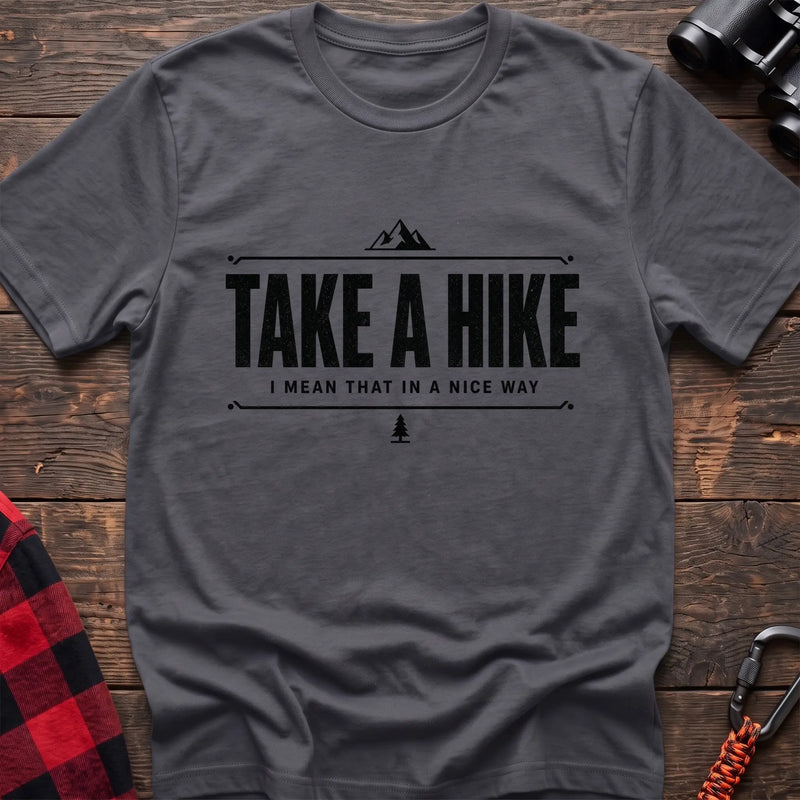 Charcoal cotton hiking t-shirt with "Take a Hike I Mean That in a Nice Way" quote, mountain icon, and pine tree graphic