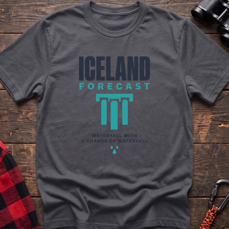 Charcoal cotton t-shirt with an Iceland Forecast graphic and Waterfall with a Chance of Waterfall text on rustic wood