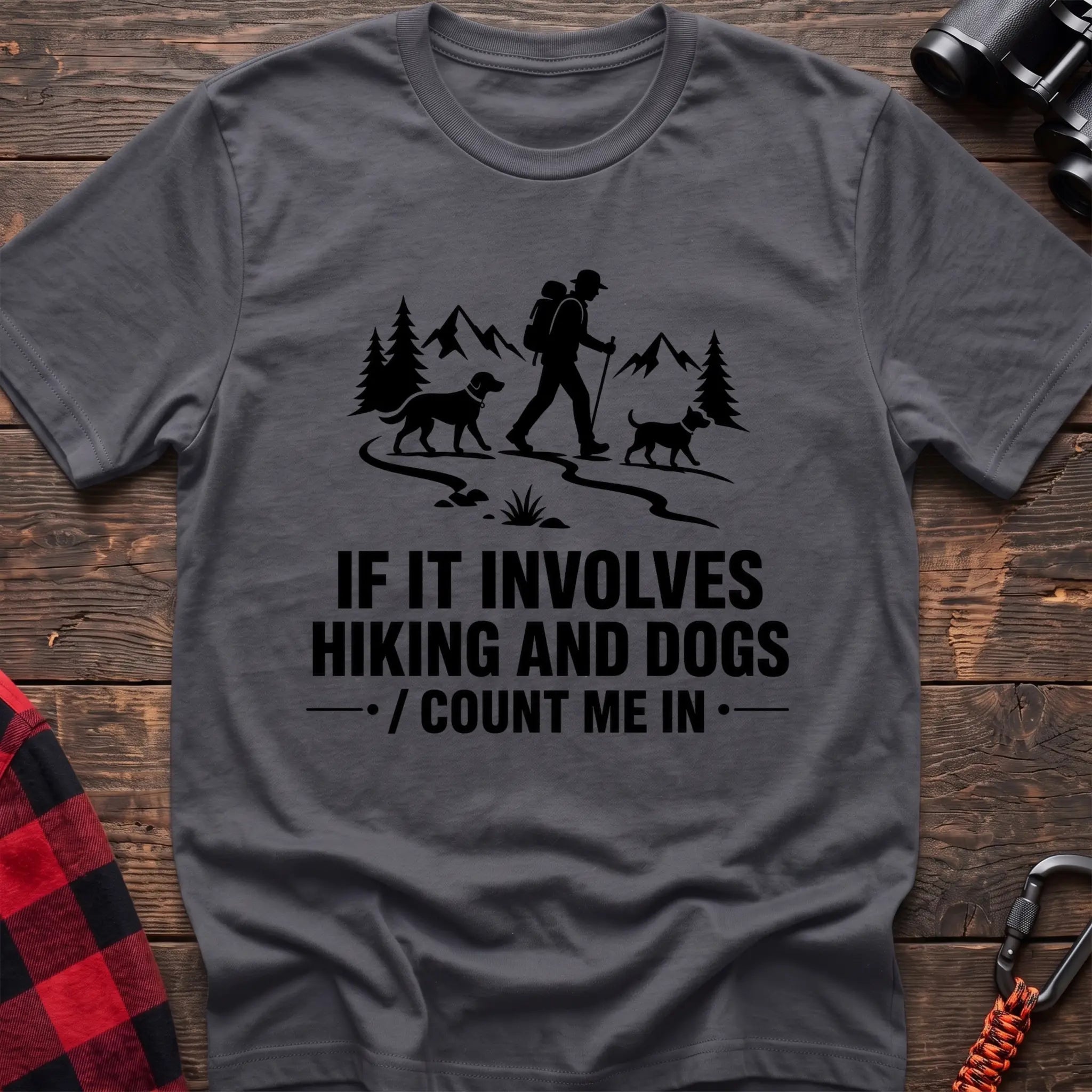 Charcoal cotton hiking t-shirt with hiker and two dogs silhouette on a mountain trail and "If it involves hiking and dogs count me in" quote