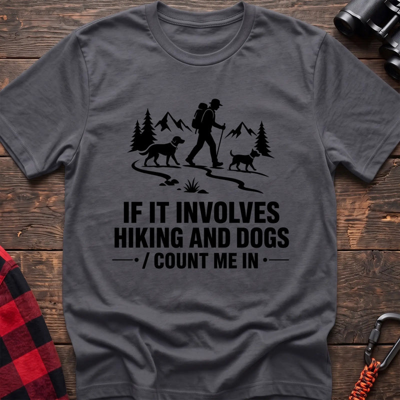 Charcoal cotton hiking t-shirt with hiker and two dogs silhouette on a mountain trail and "If it involves hiking and dogs count me in" quote