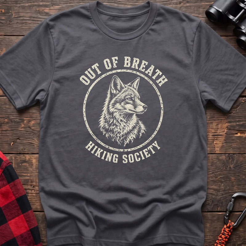Charcoal cotton t-shirt with a wolf graphic and Out of Breath Hiking Society text on rustic wood