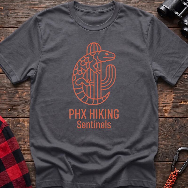 Charcoal t-shirt with orange line-art Gila monster wrapped around a saguaro cactus and the text “PHX HIKING Sentinels”