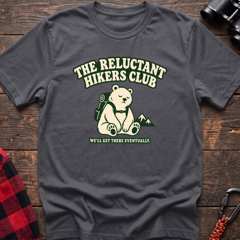 Charcoal cotton t-shirt with a sitting backpack bear graphic and The Reluctant Hikers Club text on rustic wood