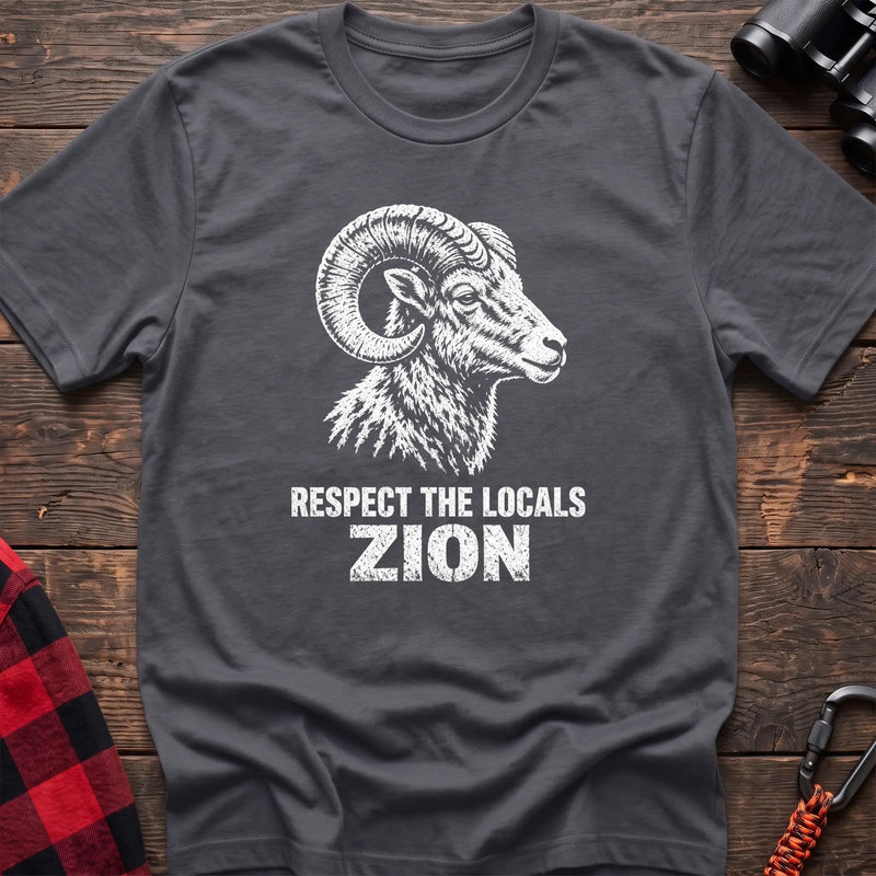 Charcoal cotton t-shirt with a bighorn ram graphic and Respect the Locals Zion text on rustic wood
