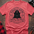 Coral silk cotton t-shirt with vintage Asheville Hiking Cougar League graphic of a roaring cougar in a park ranger hat, Protect the Trails North Carolina Wildlife Division badge, flat lay on rustic wood with hiking gear