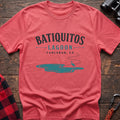Coral silk cotton t-shirt with a heron and lagoon graphic and Batiquitos Lagoon Carlsbad CA text on rustic wood