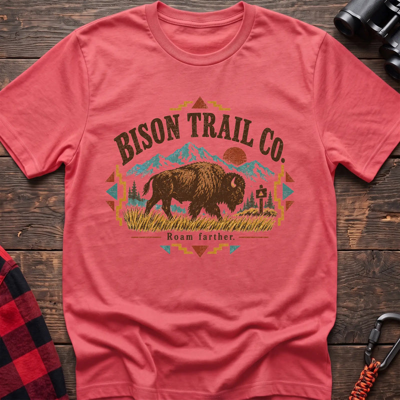Coral silk cotton t-shirt with a bison and mountain graphic and Bison Trail Co text on rustic wood
