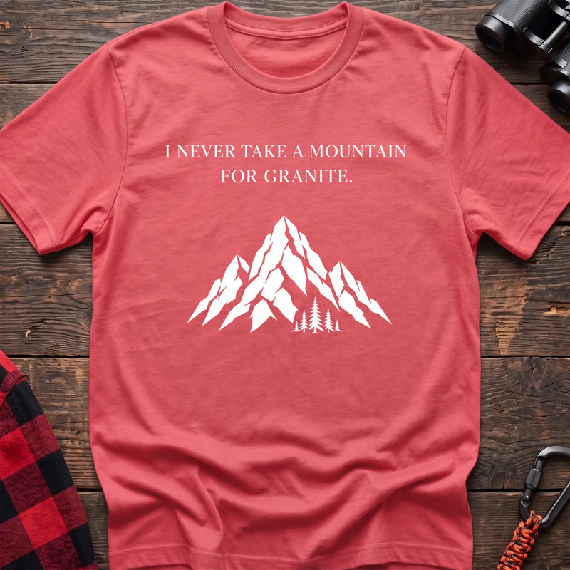 Coral silk cotton t-shirt with a mountain graphic and I Never Take a Mountain for Granite text on rustic wood