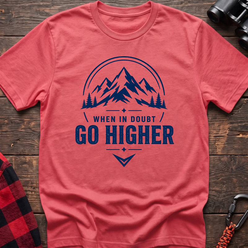Coral silk cotton hiking t-shirt with navy mountain and pine tree graphic and "When in doubt go higher" quote