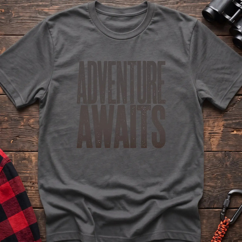 Graphite heather t-shirt with large distressed gray text reading Adventure Awaits