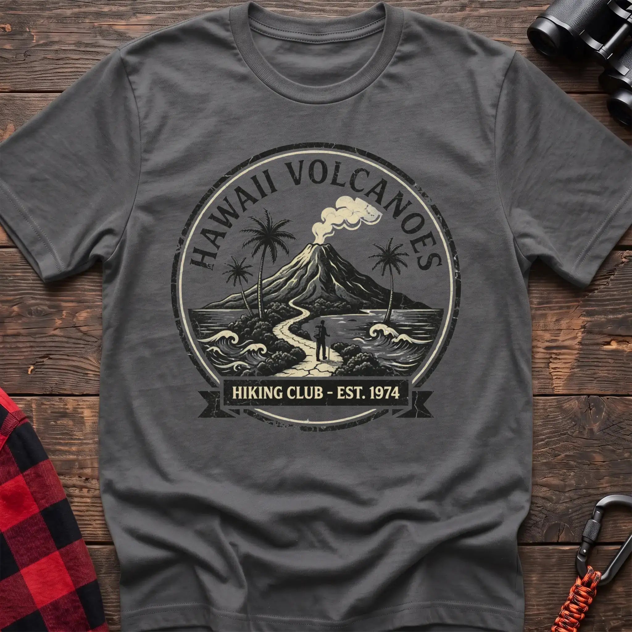 Graphite heather t-shirt with circular Hawaii Volcanoes badge graphic showing a volcano, palm trees, and a hiker, reading Hiking Club Est 1974