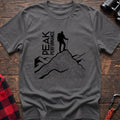 Graphite heather t-shirt with hiker silhouette on a topographic mountain peak and the text Peak Performance