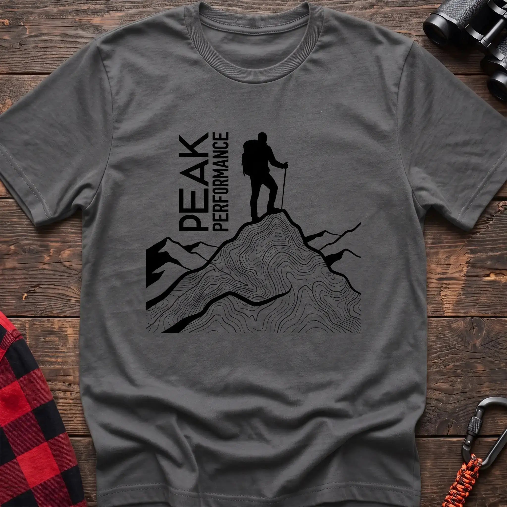 Graphite heather t-shirt with hiker silhouette on a topographic mountain peak and the text Peak Performance