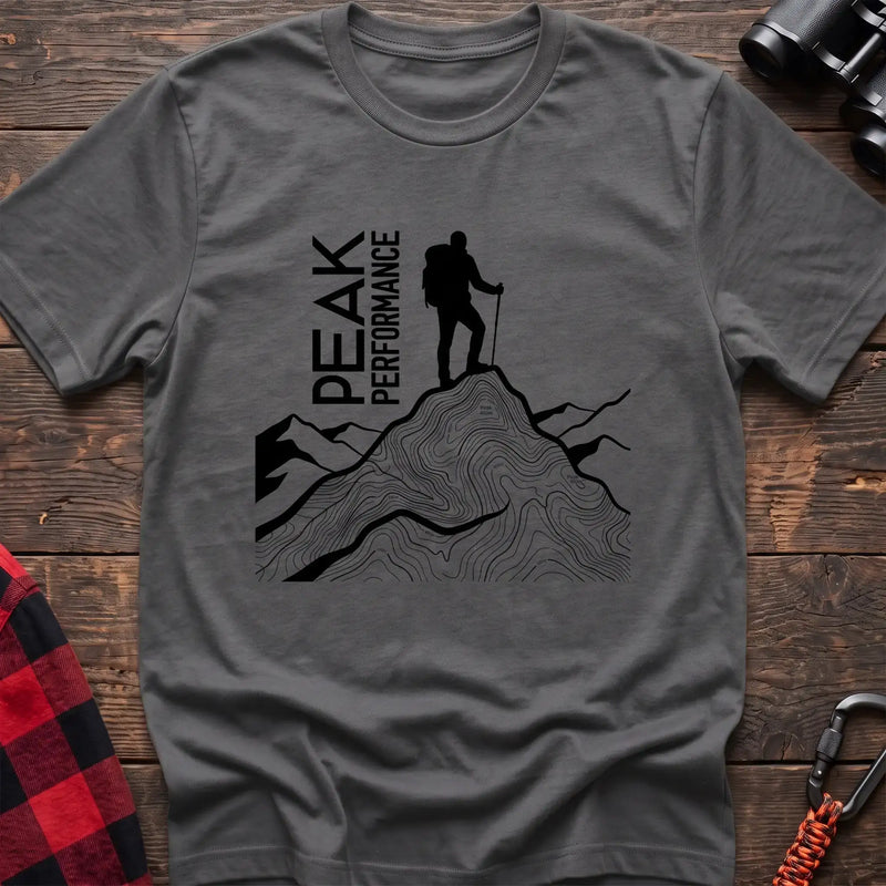 Graphite heather t-shirt with hiker silhouette on a topographic mountain peak and the text Peak Performance