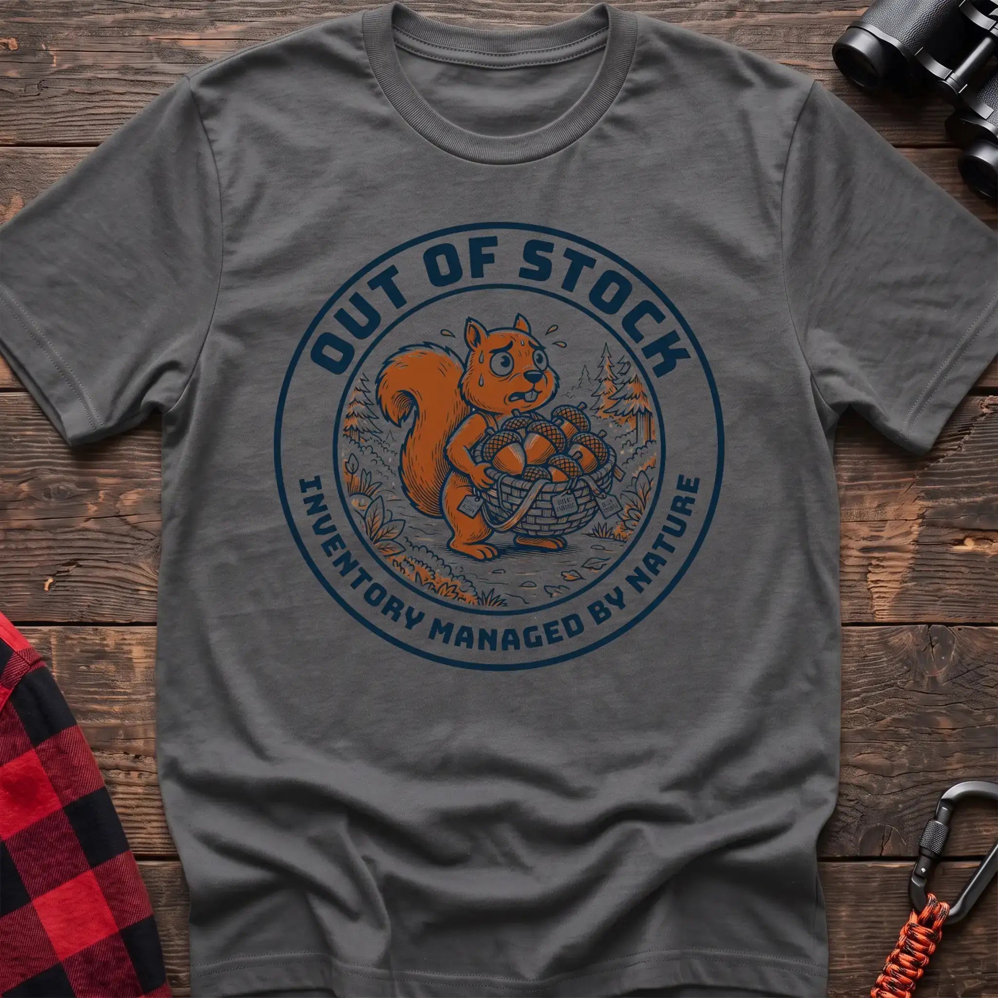 Graphite heather t-shirt with circular graphic of a stressed squirrel holding a basket of acorns, reading Out of Stock Inventory Managed by Nature
