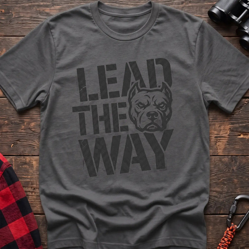Graphite heather t-shirt with a distressed graphic of a stern pit bull head integrated into the bold text “LEAD THE WAY,” laid flat on a wooden surface.