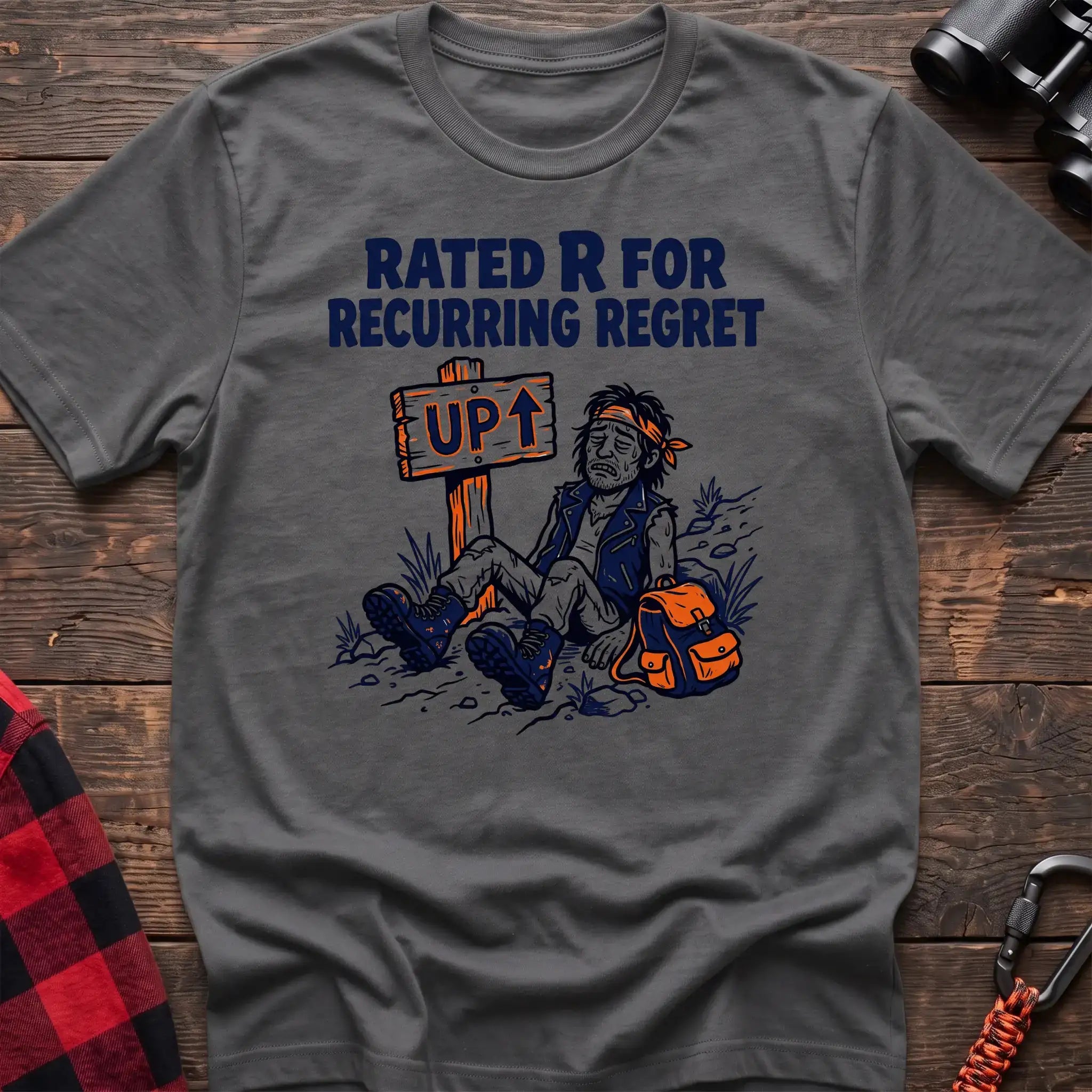 Graphite heather t-shirt with illustration of an exhausted hiker sitting by an UP trail sign and the text Rated R for Recurring Regret